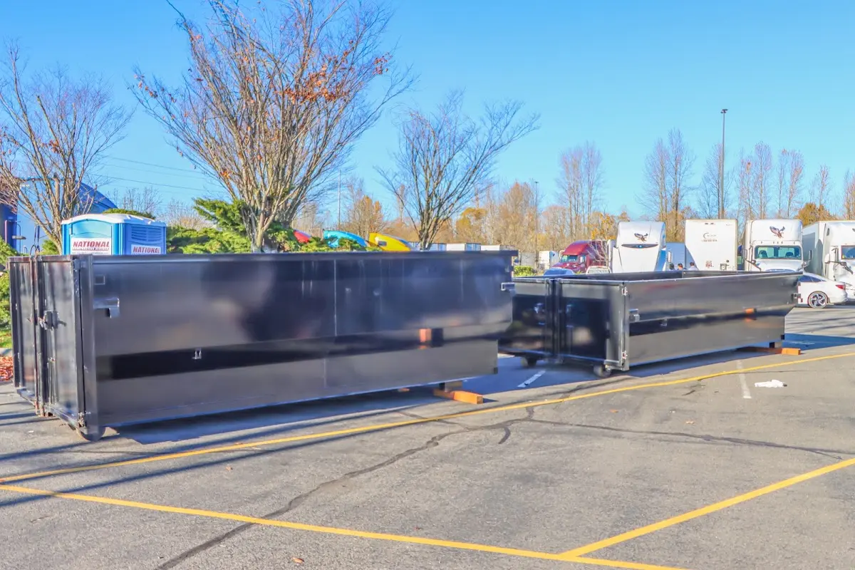 Professional dumpster rental service with roll-off container on residential driveway in Campton Hills